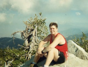 Anita Knowles relaxing at the top of a mountain